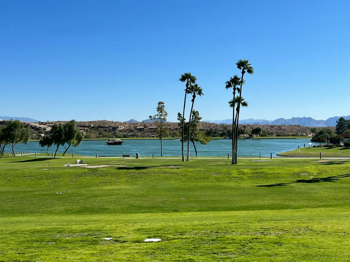 Golf course with palms and a lake