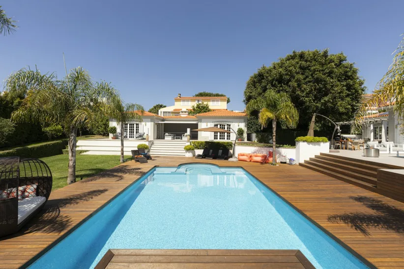 Luxury pool home with tropical landscaping
